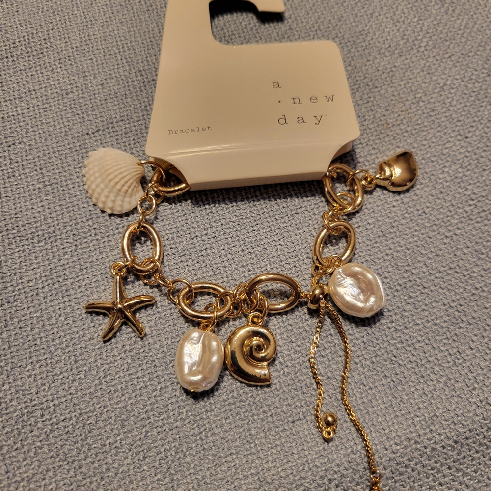A New Day Gold and White Shell Charm Bracelet